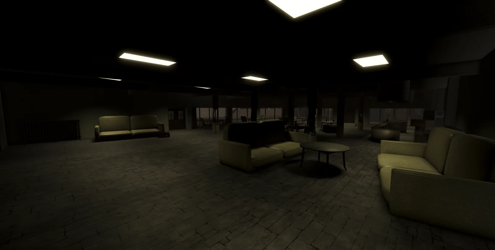 Dim lounge with circular seats and overhead lighting