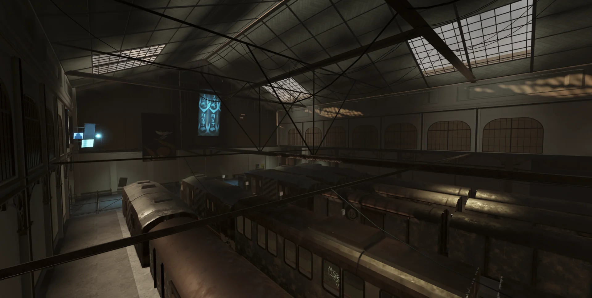 Industrial train station hall with overhead beams and illuminated screens